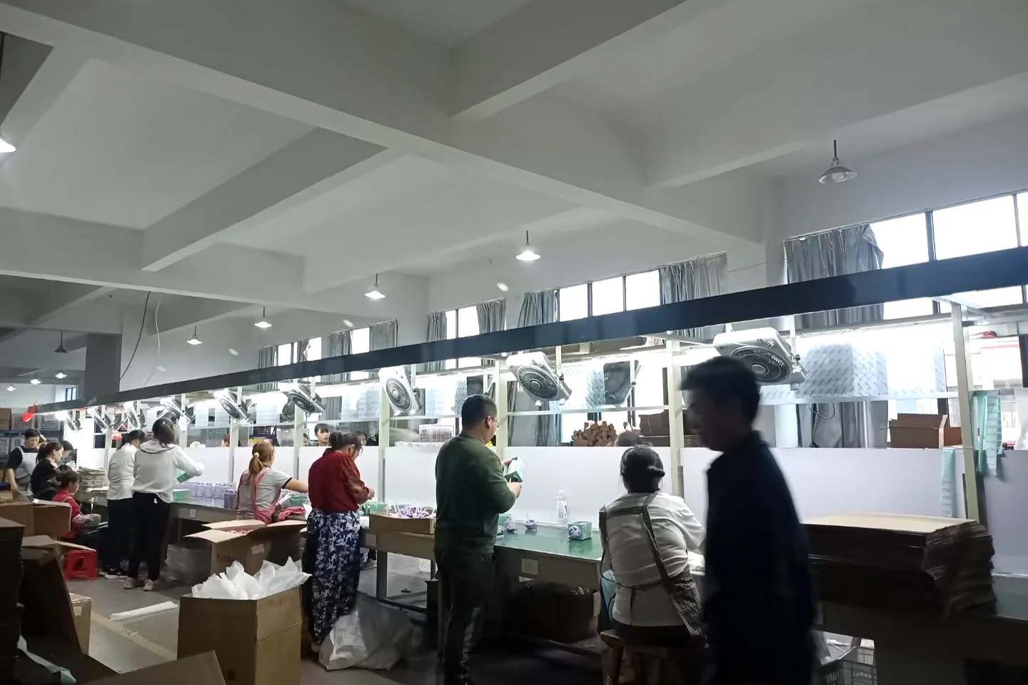 BG Drinkware workers coordinating along an assembly line