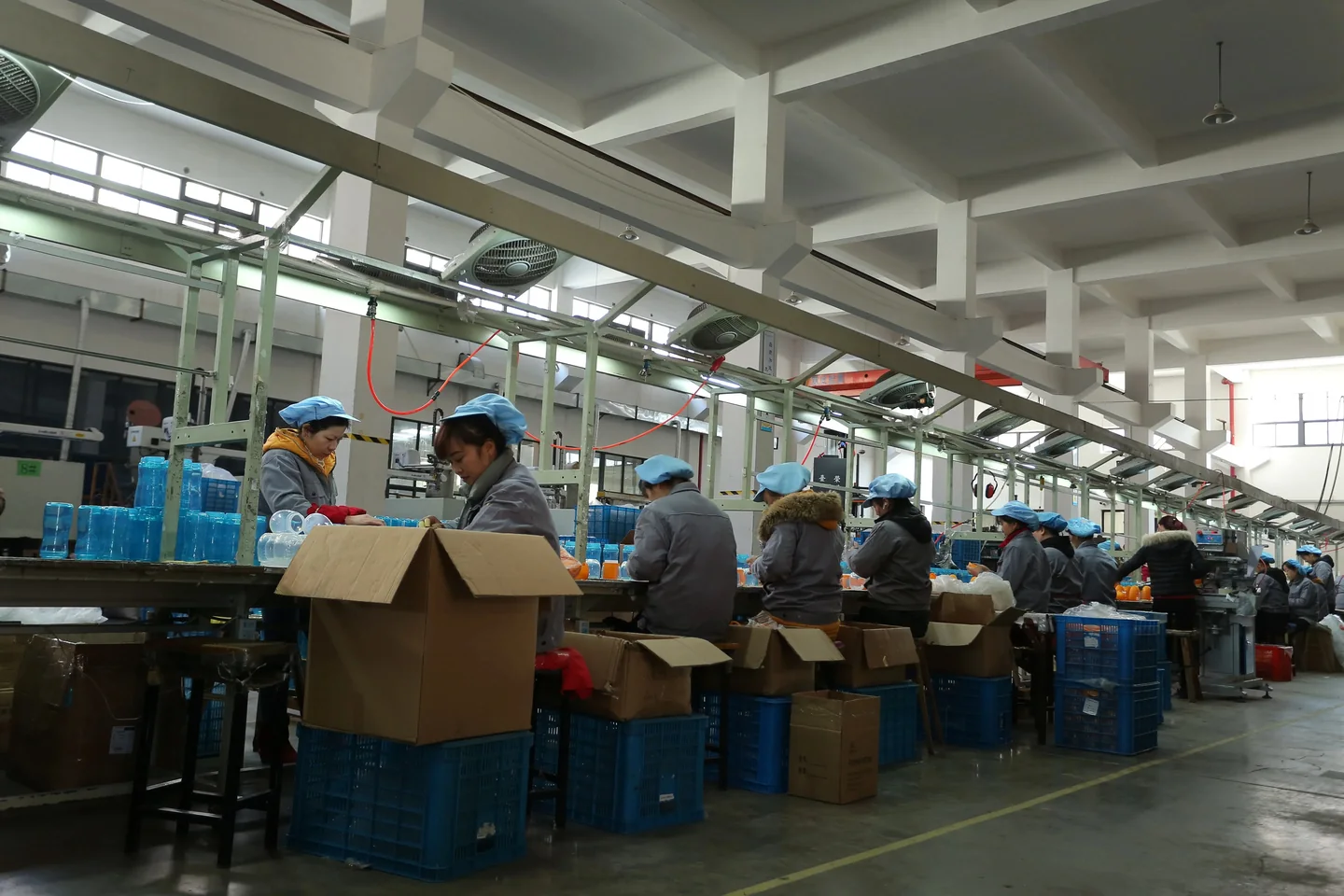 BG Drinkware team working along a drinkware assembly and packing line